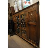 An oak book case fitted with a single le