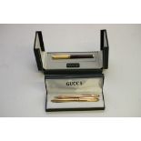 A boxed Gucci ballpoint pen, another by