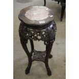 A carved oriental jardiniere stand inset