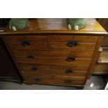 A satin walnut chest of drawers