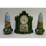 A ceramic clock garniture decorated with