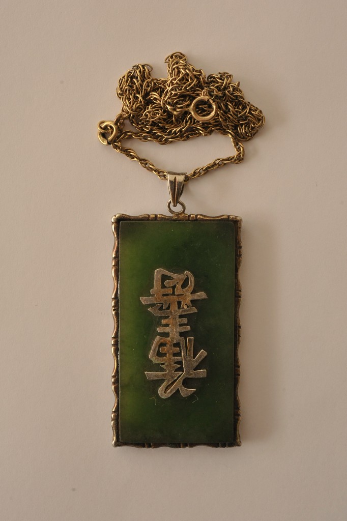 A rectangular jade pendant with applied