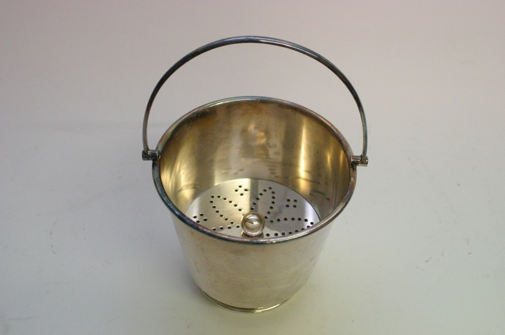 A silver plated ice bucket having inner