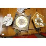 three continental wall clocks of various