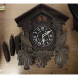 A carved oak Black Forest cuckoo clock