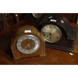 An oak mantel clock and a walnut mantel