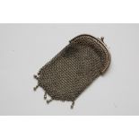 A small silver chainmail mesh purse