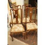 A set of four mahogany dining chairs wit
