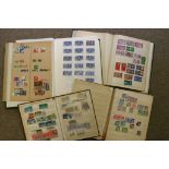 A collection of four stamp albums and st