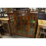 An unusual walnut display cabinet with a