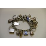 A silver charm bracelet set with numerou