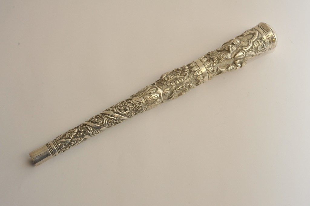 An Indian white metal parasol handle wit