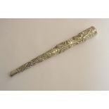 An Indian white metal parasol handle wit