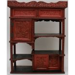 A small Chinese red lacquered cabinet wi