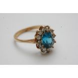 A 9ct gold ring inset with a pale blue s