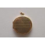 A 9ct gold locket of circular shape with