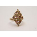 A 9ct gold ring of marquise shape set wi