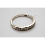 A white gold half hoop eternity ring