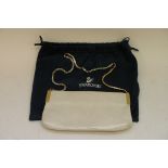 A ladies Swarovski evening bag in cream mock animal patent with swarovski crystal strap.