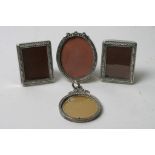 Four miniature silver photo frames including one pair