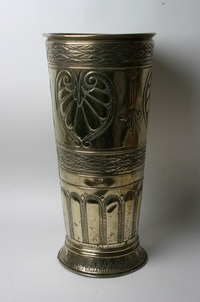 A brass stick stand decorated in the Art Nouveau style.