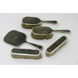 A silver and torteshell dressing table set including a mirror and brushes