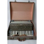 A cased Coronado Italian accordion.