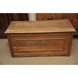 A carved oak chest with a hinged lid