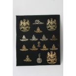 A collection of sixteen various artillery badges including three helmet plates and one busby