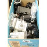 A box containing various cameras and lenses including Nikon and Canon