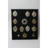 A collection of thirteen various Argyl + Sutherland badges including Plaid brooch