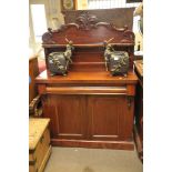A Victorian mahogany chiffonier with carved scroll work decoration.