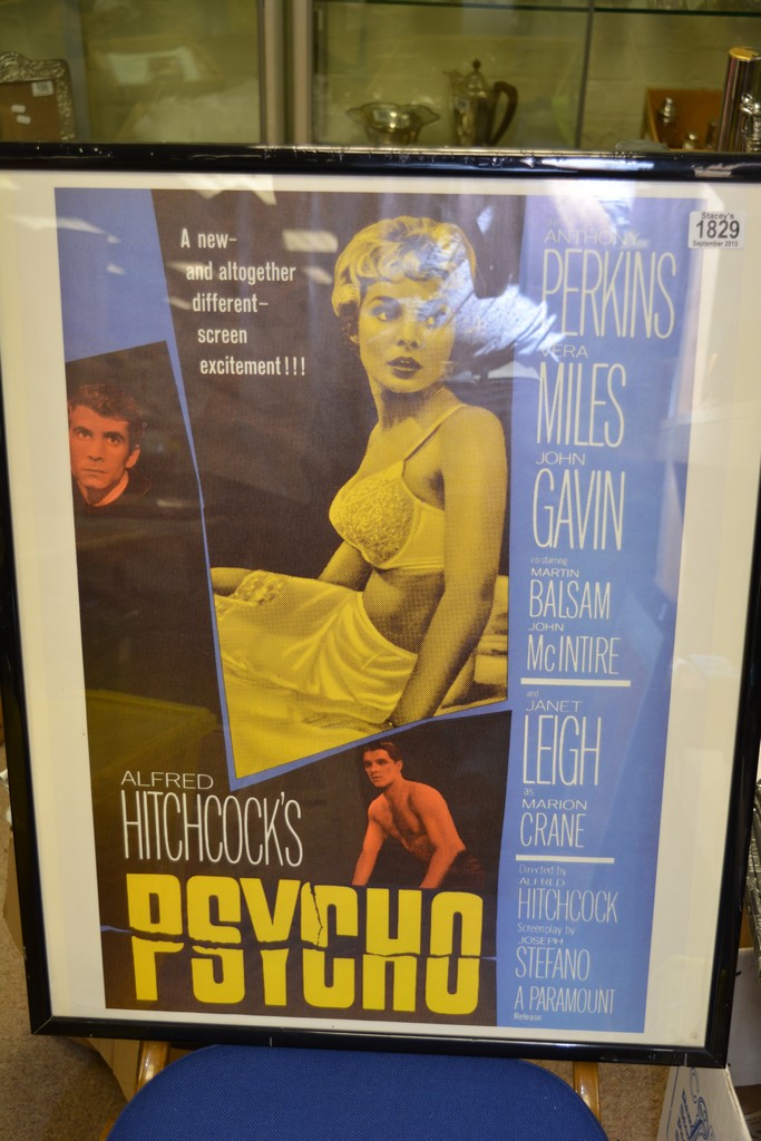 A framed film poster for Alfred Hithcocks film "Psycho"