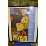 A framed film poster for Alfred Hithcocks film "Psycho"