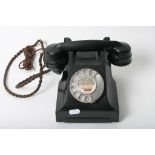 A black bakelite telephone marked CY66.