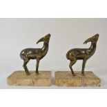 A pair of Art Deco bookends the marble bases surmounted with deer
