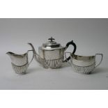 A silver Mappin and Webb three piece teaset of Classical style with gadrooned detail,