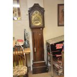 A long case clock, the brass dial with Roman numerals,