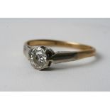 A diamond solitaire ring set in 18ct gold and platinum