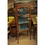An Edwardian inlaid single door display cabinet fitted with three shelves and raised on splayed