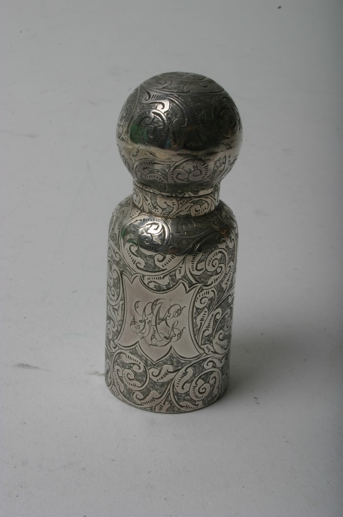A Victorian silver scent bottle with engraved scrolled decoration,