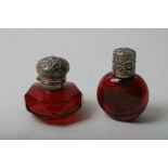 Two silver topped miniature red glass scent bottles