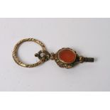 An antique watch key inset with cut and polished stones