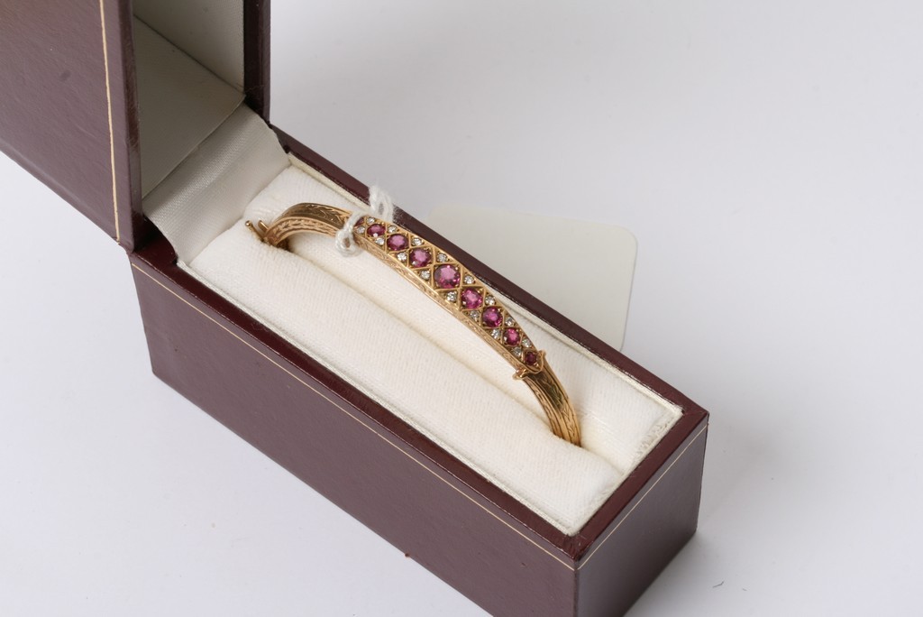 A quality 9ct gold bangle set with graduating Ruby's and diamonds