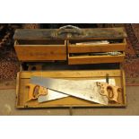 A wooden tool chest containing various saws, planes etc.