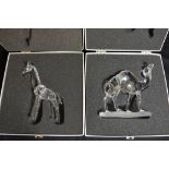 A boxed Swarovski camel and giraffe