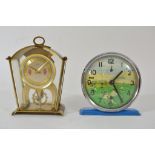 Two mid 20th century clocks comprising a Sturm example depicting a game of football,