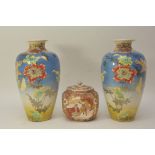 A pair of early 20th Century Satsuma vases decorated with flowers on a deep blue ground,