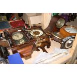 A collection of various mantle and wall clocks and a barometer