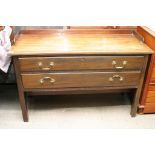 A mahogany serving table with raised gallery and fitted with two drawers